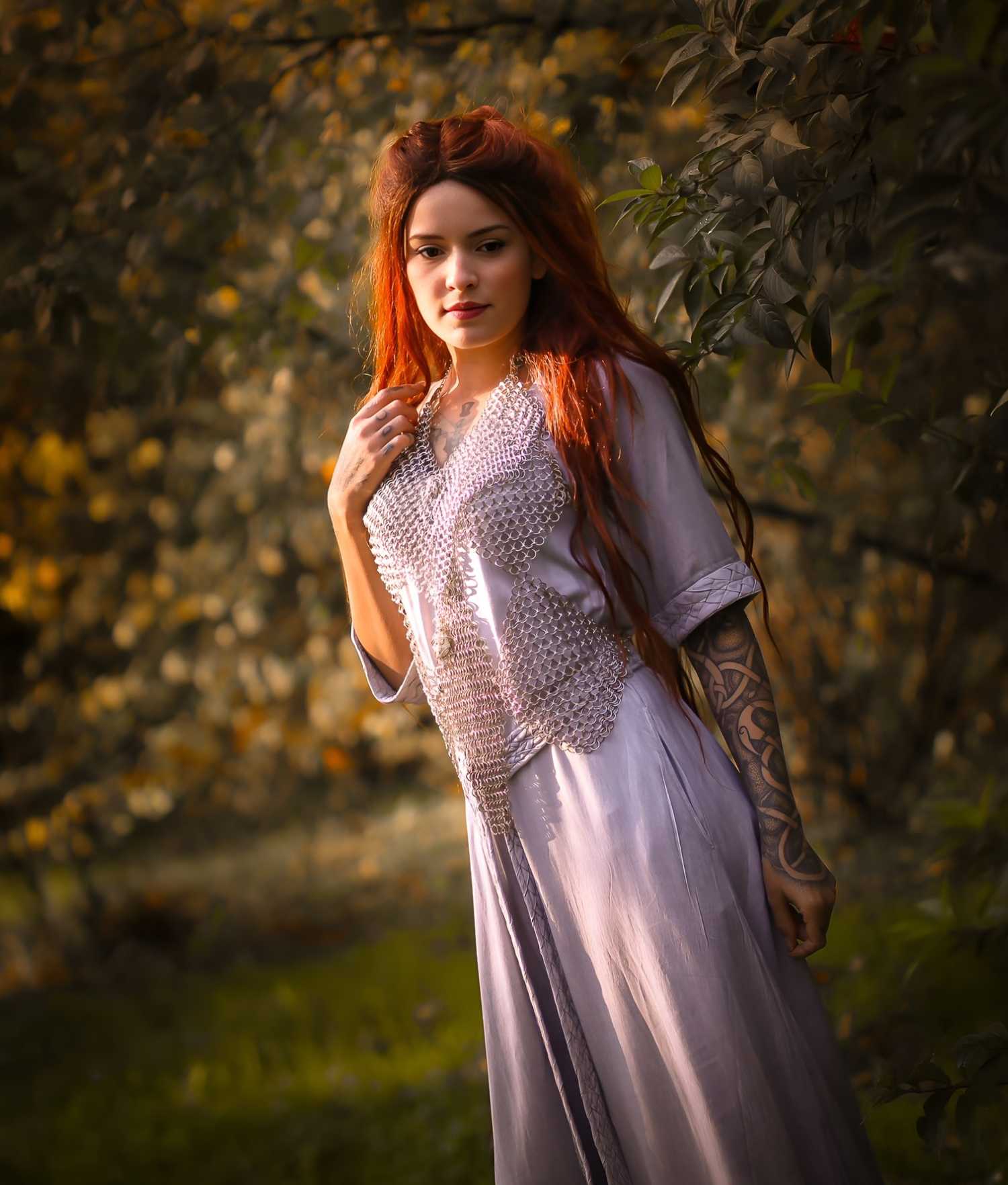 woman wearing an elegant dress under a top maide of chain