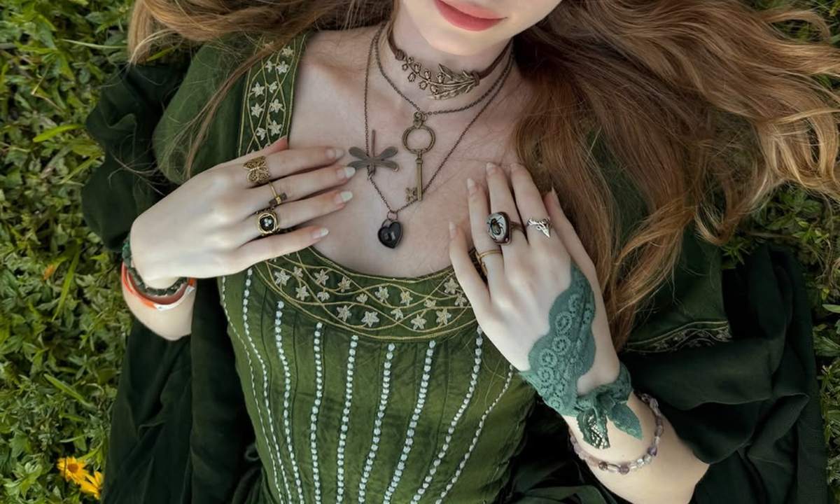 woman wearing a beautiful green renaissance dress and jewelries
