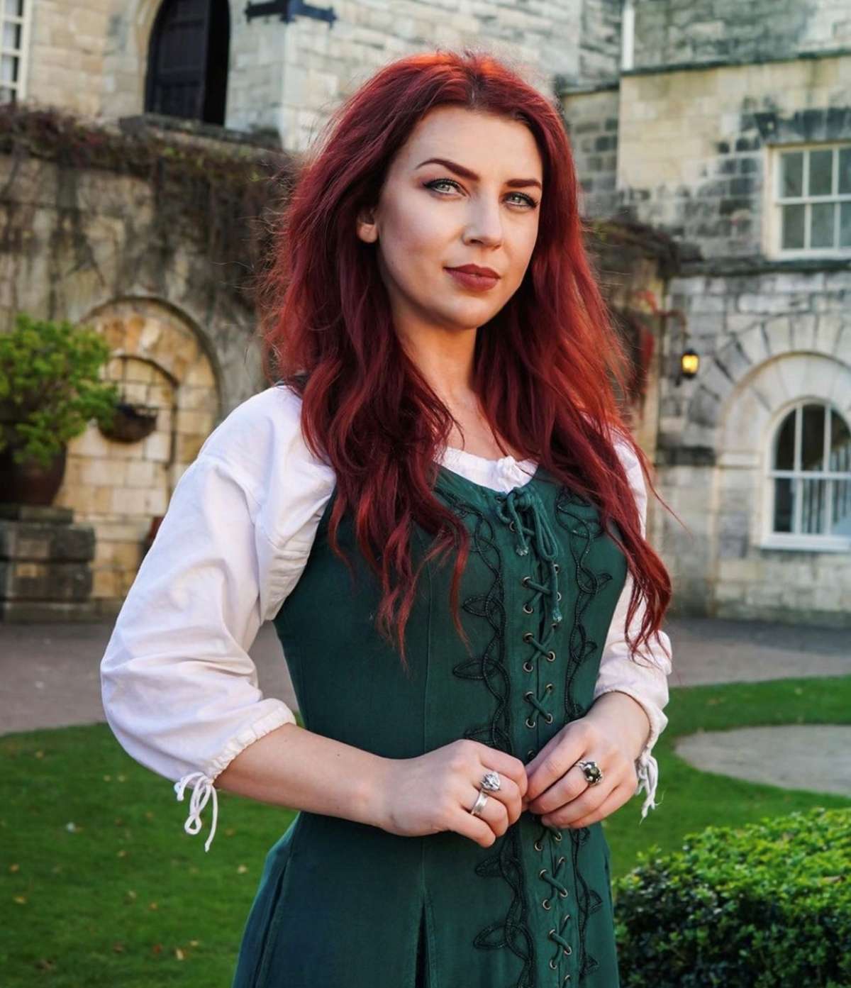 woman with beautiful red hair wearing a green renaissance dress