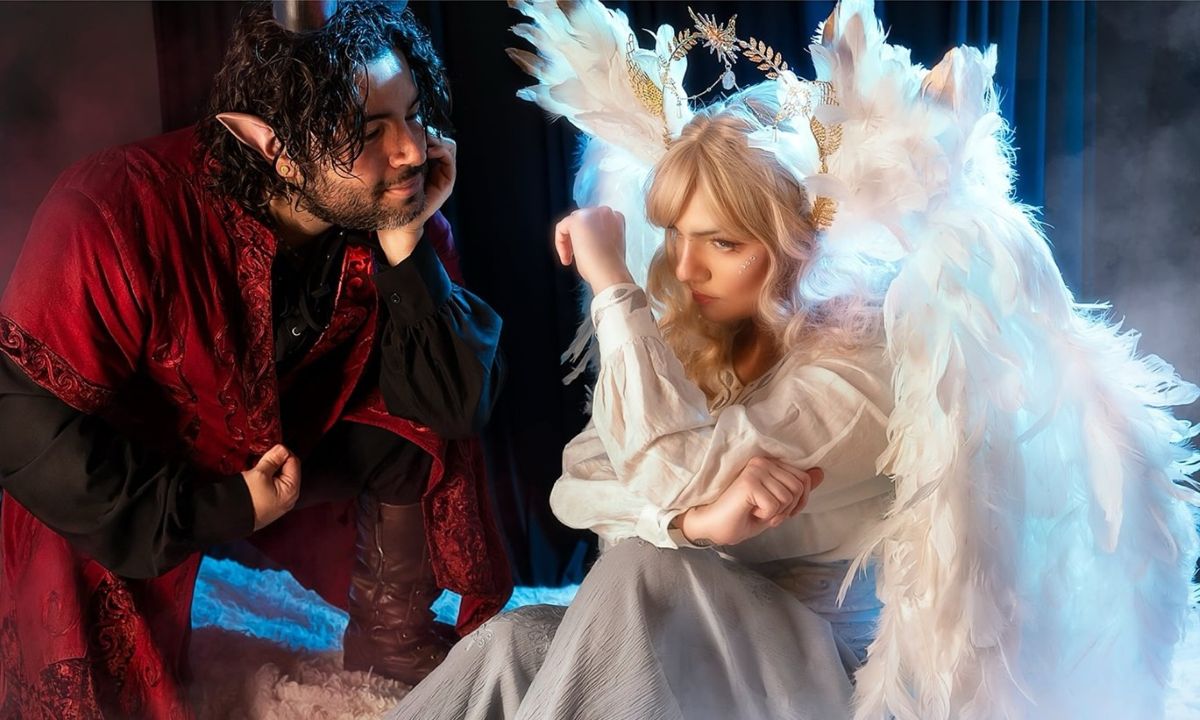 man with elf ears wearing a red silk robe with a woman wearing a fairy costume